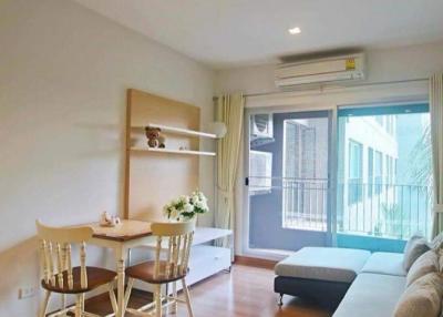 Cozy living room with natural light and balcony access