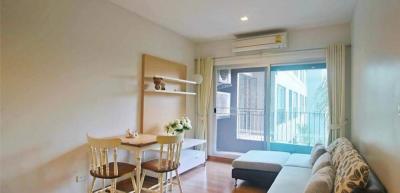 Cozy living room with natural light and balcony access