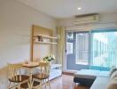 Cozy living room with natural light and balcony access