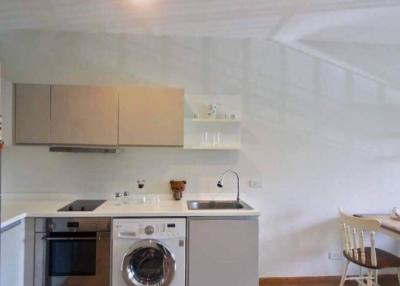 Modern kitchen with stainless steel appliances and dining area