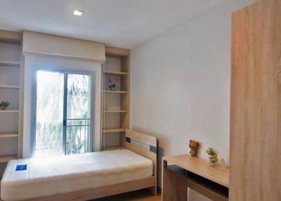 Cozy bedroom with natural light and built-in shelves