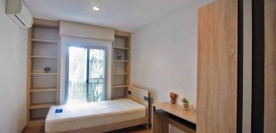 Cozy bedroom with natural light and built-in shelves