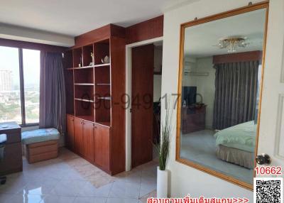 Spacious bedroom with built-in wardrobes and city view