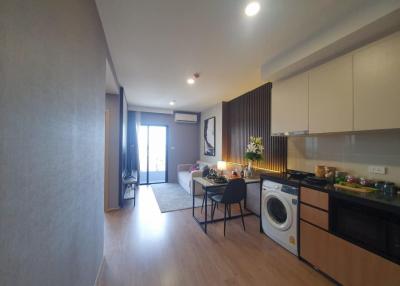 Modern kitchen with open plan living space, wooden floors and fully equipped with appliances