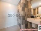 Modern bathroom with grey tiles and white fixtures