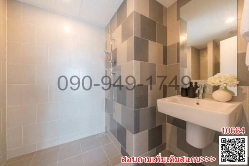 Modern bathroom with grey tiles and white fixtures