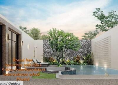 Luxurious pool villa with garden and lounge chairs