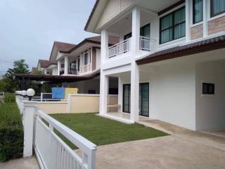 Suburban two-story house with lawn and balcony