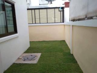 Compact backyard with artificial turf and high privacy walls