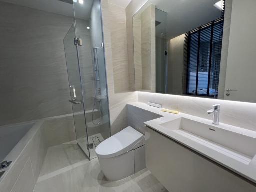 Modern bathroom with glass shower enclosure and large bathtub