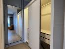 Modern corridor with built-in wardrobe and wooden flooring