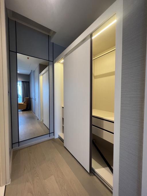 Modern corridor with built-in wardrobe and wooden flooring