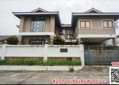 Modern two-story residential building with a white fence