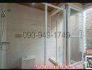 Modern bathroom interior with glass shower and textured tiles