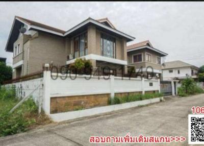 Exterior view of a two-story residential house with a fenced yard