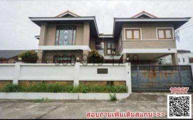 Modern two-story residential building with fenced perimeter