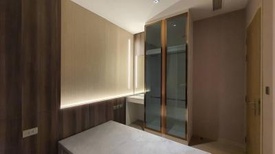 Modern bedroom with built-in wardrobe and ambient lighting