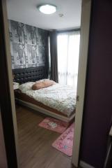 Cozy bedroom with modern wallpaper and natural light