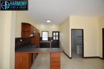 Spacious kitchen with modern amenities and attached utility area