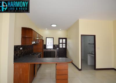 Spacious kitchen with modern amenities and attached utility area