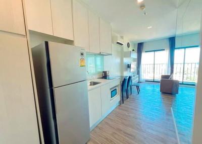 Modern apartment kitchen with open plan living space, natural light