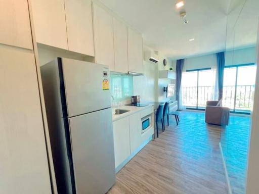 Modern apartment kitchen with open plan living space, natural light