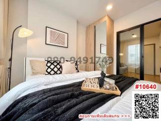 Modern bedroom interior design with artwork and cozy bedding
