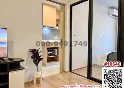 Cozy bedroom with attached kitchenette and mirrored closet doors