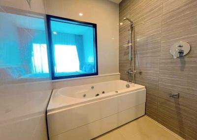 Modern bathroom interior with jacuzzi tub and tiled walls