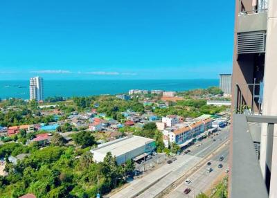 Panoramic view from a high-rise building showing a cityscape and coastline