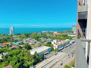 Panoramic view from a high-rise building showing a cityscape and coastline