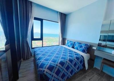 Bright bedroom with a view and blue color scheme