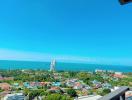 Spectacular coastal view from a high-rise balcony overlooking the sea and surrounding community