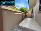 Paved side yard with high privacy walls in a residential property