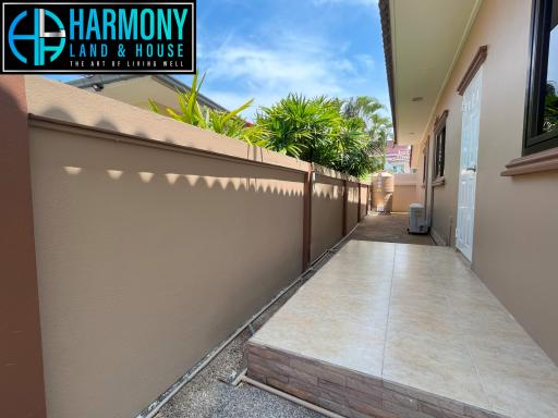 Paved side yard with high privacy walls in a residential property