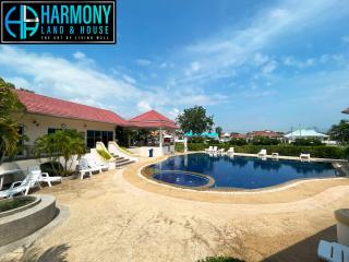 Residential outdoor swimming pool with patio and sun loungers