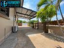 Spacious driveway with covered carport and tropical landscaping