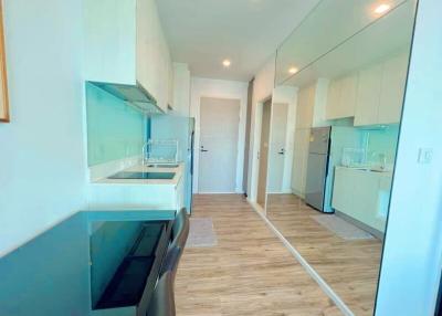 Modern kitchen with white cabinetry and wooden flooring