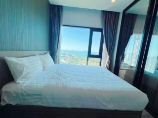 Modern bedroom with a large window and city view