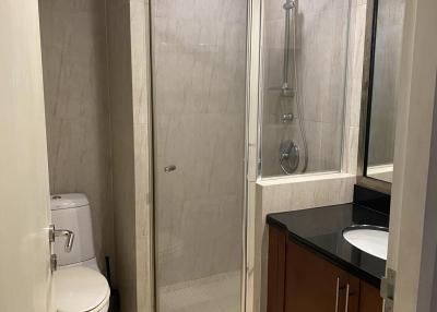 Modern bathroom with glass shower and wooden vanity