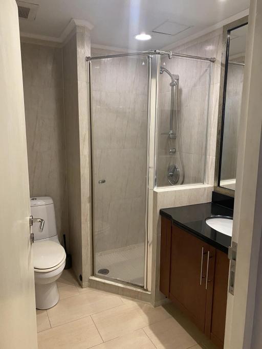 Modern bathroom with glass shower and wooden vanity