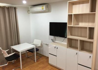 Cozy bedroom with modern furniture and wall-mounted TV