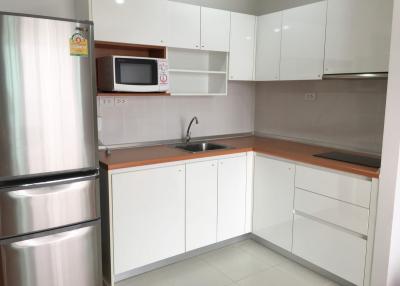 Modern white kitchen with stainless steel appliances