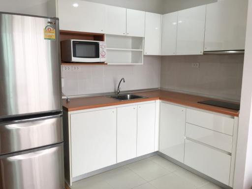 Modern white kitchen with stainless steel appliances