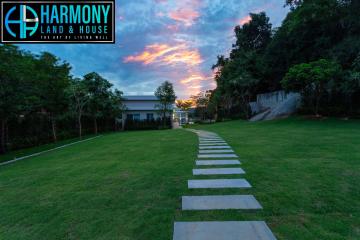 Elegant house exterior at twilight with landscaped garden and pathway