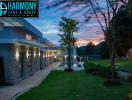 Modern residential building exterior with pool at dusk