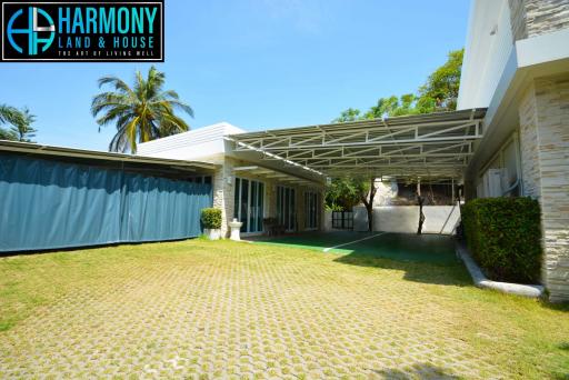 Spacious driveway with carport and greenery at modern residence