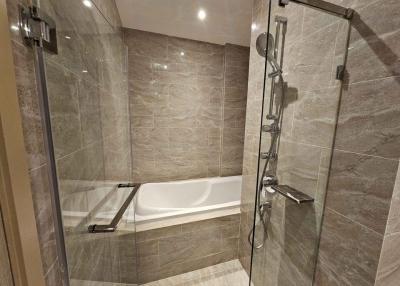 Modern bathroom with bathtub and glass shower enclosure