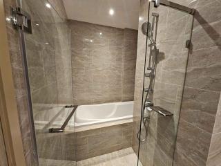 Modern bathroom with bathtub and glass shower enclosure