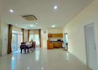 Spacious living area with dining set and open concept kitchen